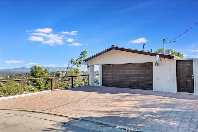 exterior space featuring a mountain view and a garage