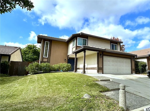 view of front of home with a front yard and a garage