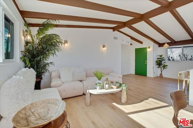 living room with lofted ceiling with beams and light wood-type flooring