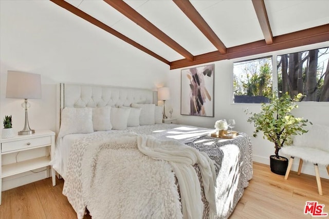 bedroom with vaulted ceiling with beams and light wood-type flooring