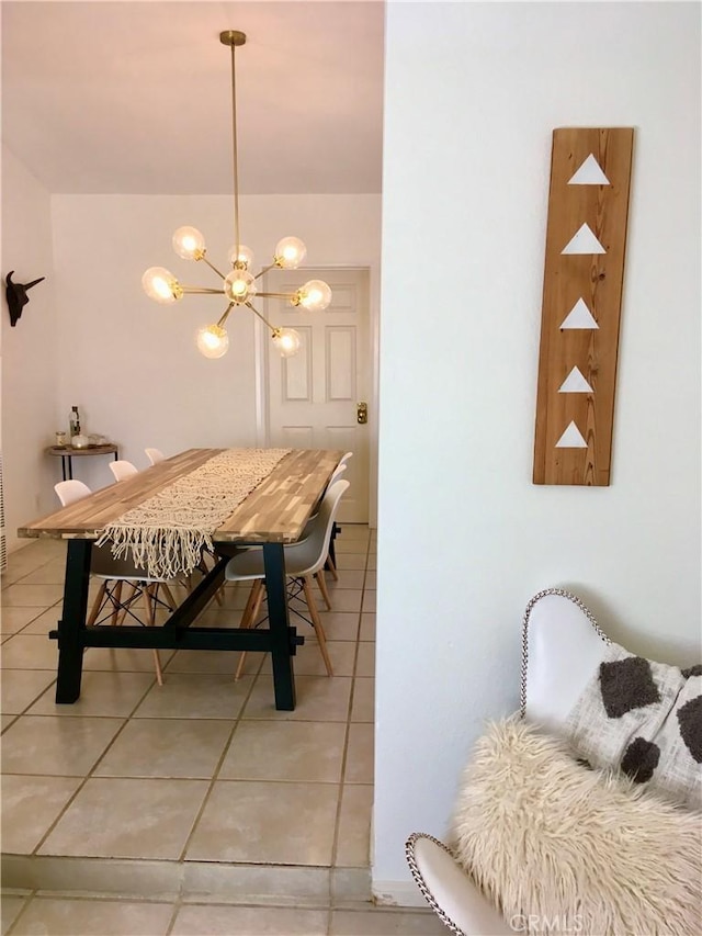 dining area with light tile patterned floors and an inviting chandelier