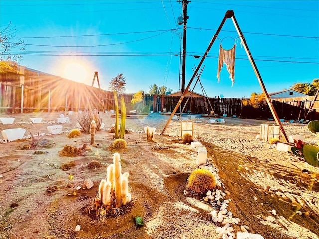 view of yard featuring a fenced backyard and a fire pit