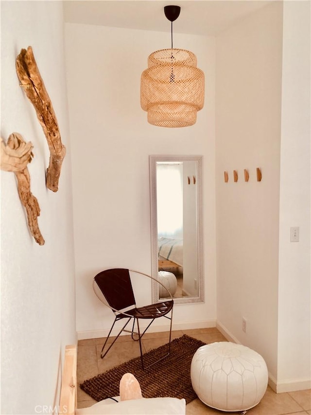 sitting room featuring baseboards and tile patterned floors