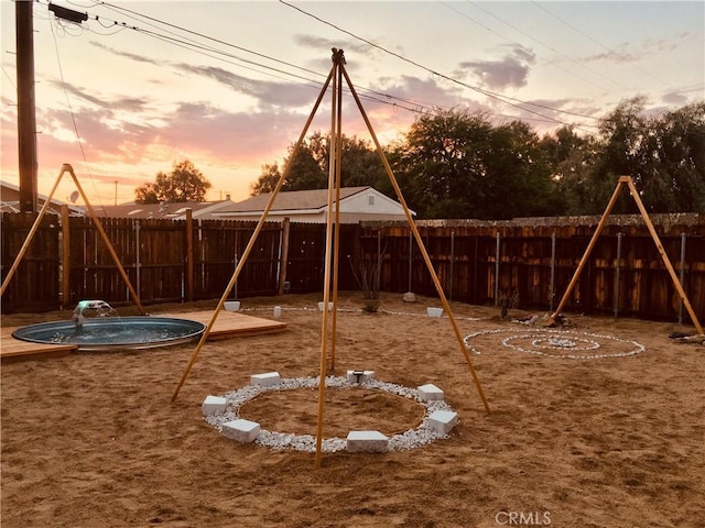 playground at dusk with a playground and fence