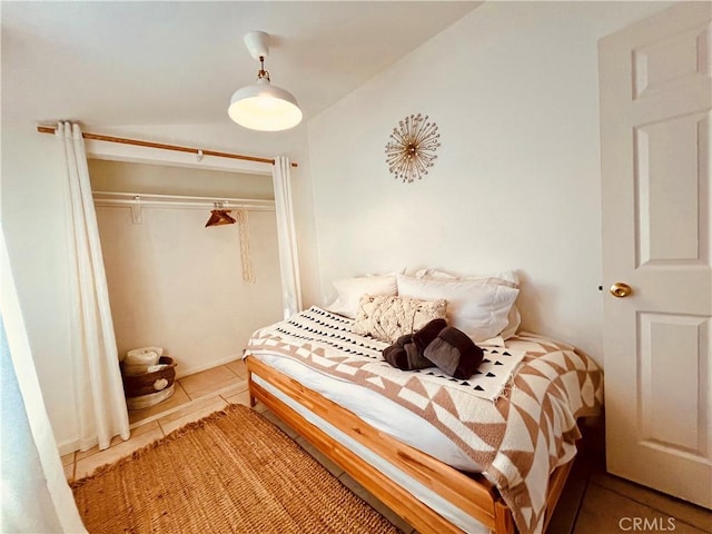 tiled bedroom with a closet