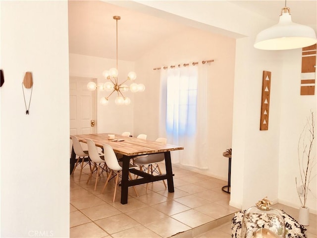 dining room with a chandelier, lofted ceiling, and light tile patterned floors