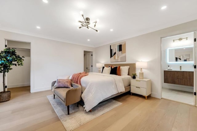 bedroom with crown molding, a chandelier, and light hardwood / wood-style flooring