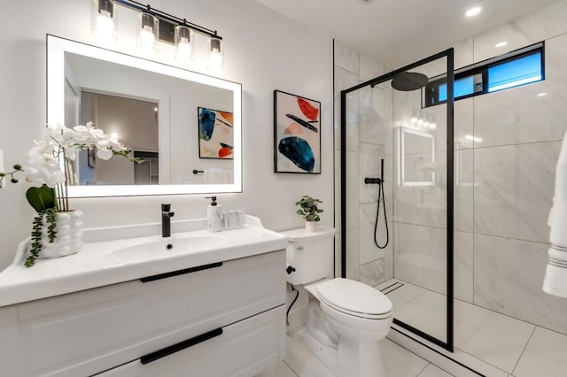 bathroom featuring vanity, tile patterned floors, toilet, and walk in shower