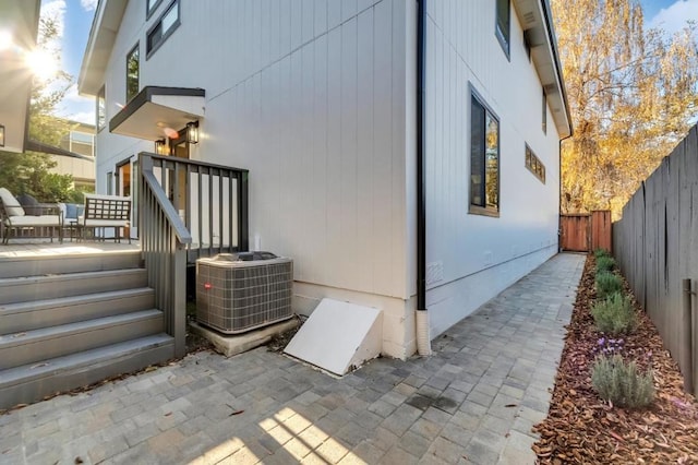 view of side of home with a patio and cooling unit