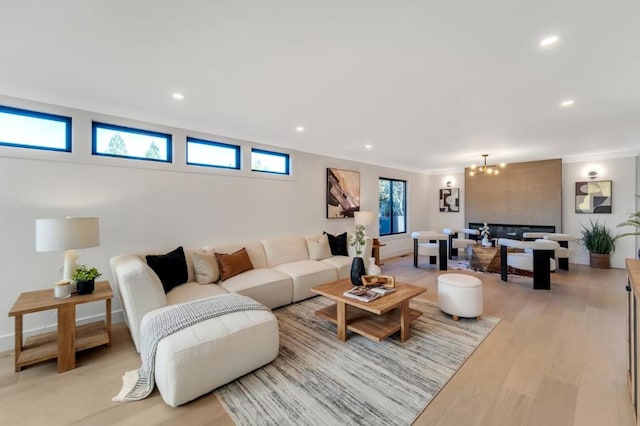 living room with a notable chandelier and light hardwood / wood-style floors