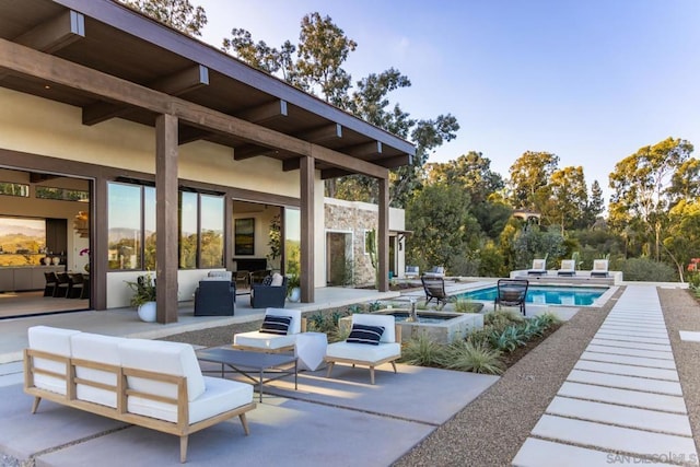 view of patio / terrace with outdoor lounge area and a swimming pool with hot tub