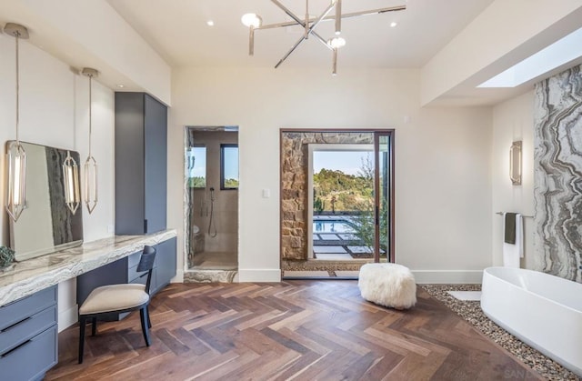 bathroom with parquet flooring, vanity, an inviting chandelier, and plus walk in shower