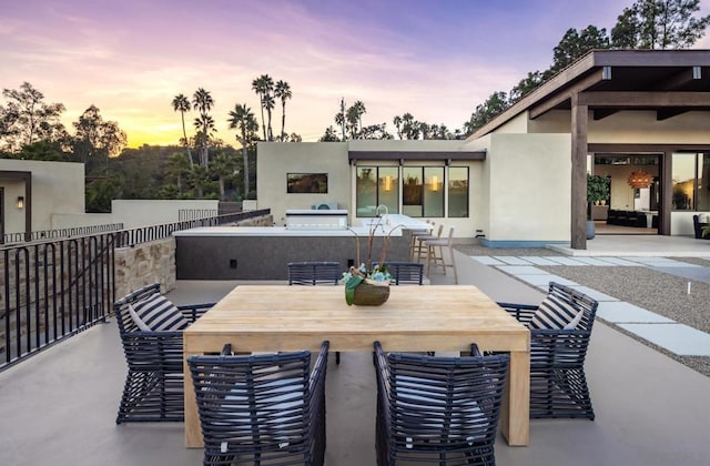 view of patio terrace at dusk