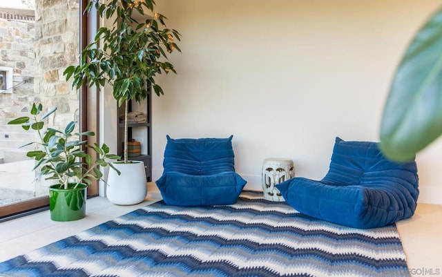 living area with tile patterned floors