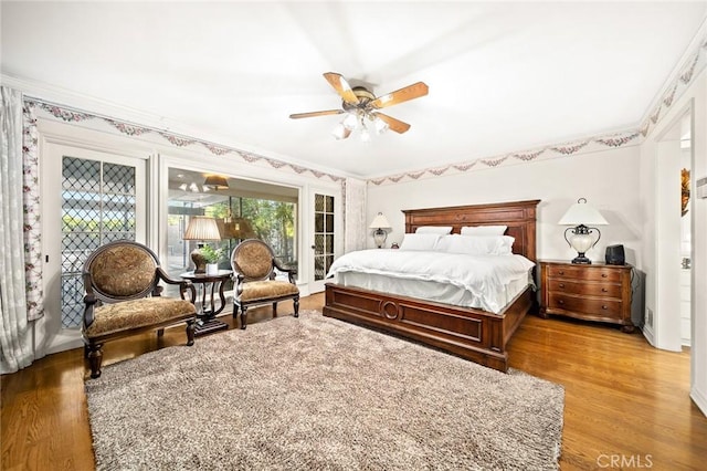 bedroom featuring ceiling fan, hardwood / wood-style floors, and crown molding