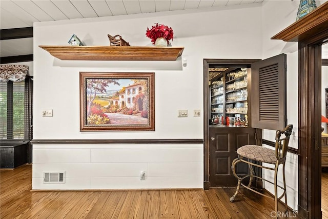 interior space featuring hardwood / wood-style floors, lofted ceiling with beams, and wood ceiling