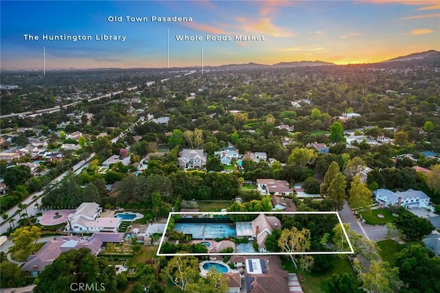 aerial view at dusk featuring a mountain view