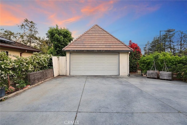 view of garage at dusk