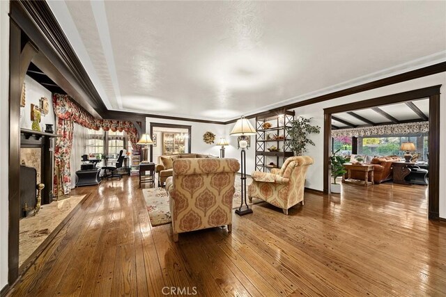 living room featuring wood-type flooring and ornamental molding