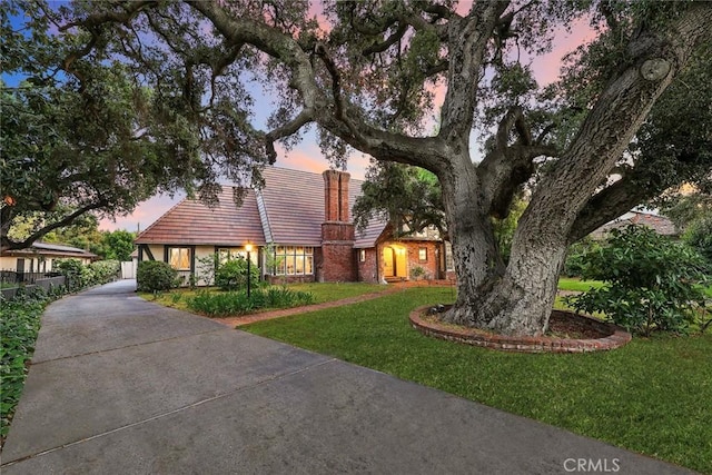 english style home with a lawn