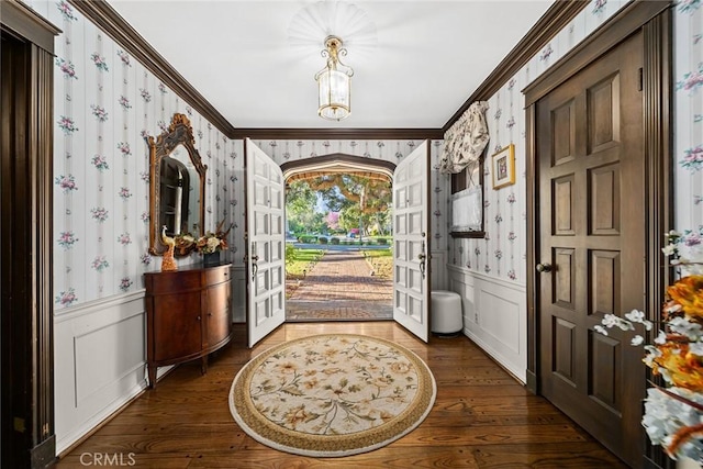 foyer entrance featuring dark hardwood / wood-style flooring, french doors, and ornamental molding