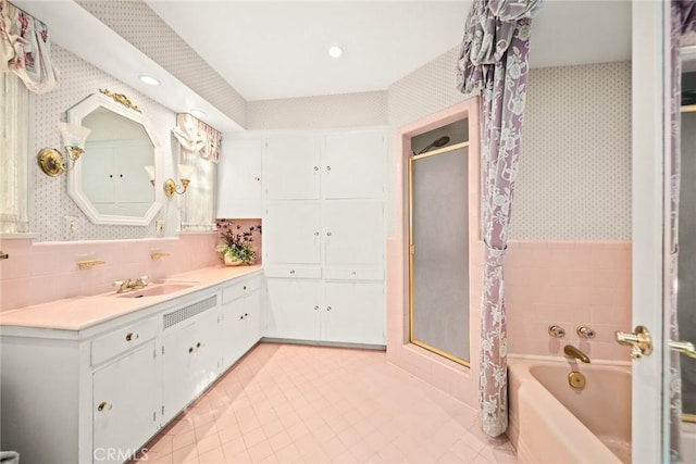 bathroom featuring plus walk in shower, tile patterned flooring, and vanity