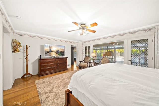 bedroom with ceiling fan, access to exterior, light wood-type flooring, and ornamental molding