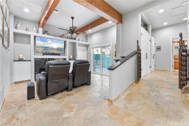 home theater room featuring beamed ceiling and ceiling fan