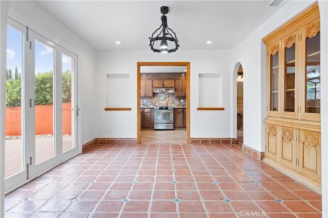 11431 Clybourn Ave, Lakeview Terrace, CA 91342 - doorway to outside with recessed lighting, visible vents, light tile patterned floors, arched walkways, and baseboards