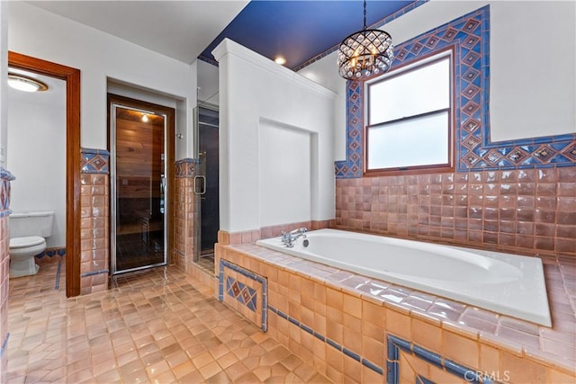 bathroom featuring tile patterned flooring, separate shower and tub, toilet, and an inviting chandelier