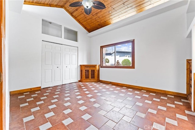 unfurnished bedroom with a closet, high vaulted ceiling, ceiling fan, and wooden ceiling