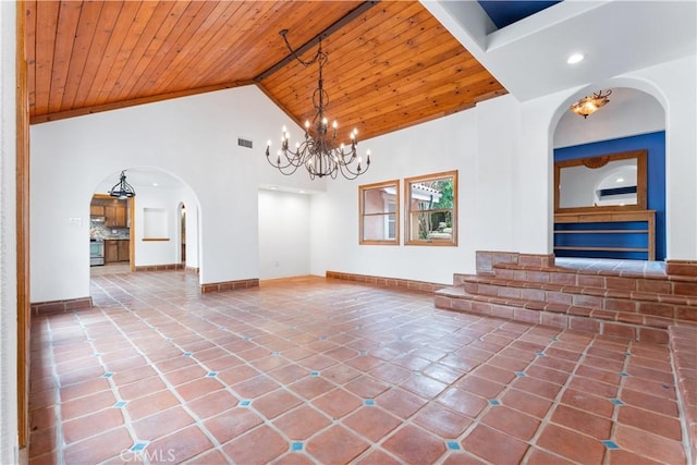 tiled empty room featuring beamed ceiling, high vaulted ceiling, wood ceiling, and a notable chandelier