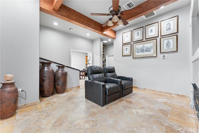 home theater room featuring beam ceiling and ceiling fan