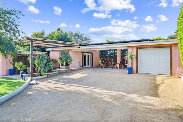 ranch-style house with french doors and a garage