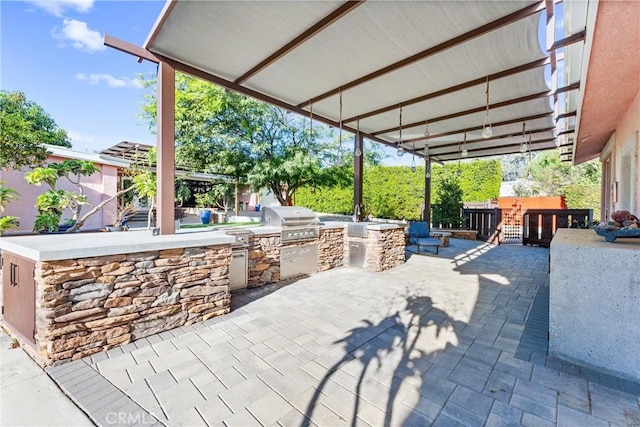 view of patio with an outdoor kitchen and area for grilling