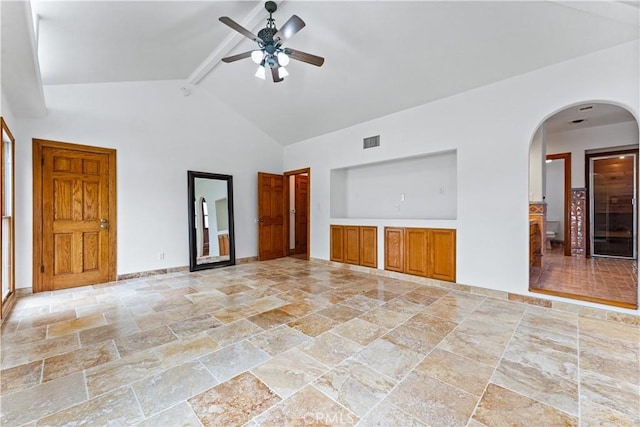 unfurnished living room featuring ceiling fan, beamed ceiling, and high vaulted ceiling