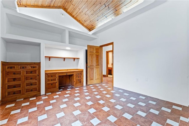 interior space featuring built in desk, high vaulted ceiling, and wooden ceiling