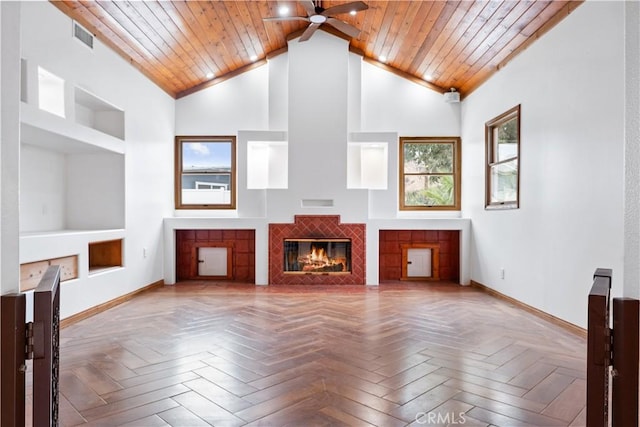 unfurnished living room featuring high vaulted ceiling, a tile fireplace, parquet flooring, and wood ceiling