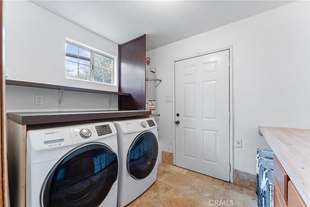 washroom with cabinets and washer and clothes dryer