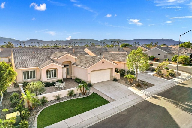 view of front of property featuring a mountain view and a garage