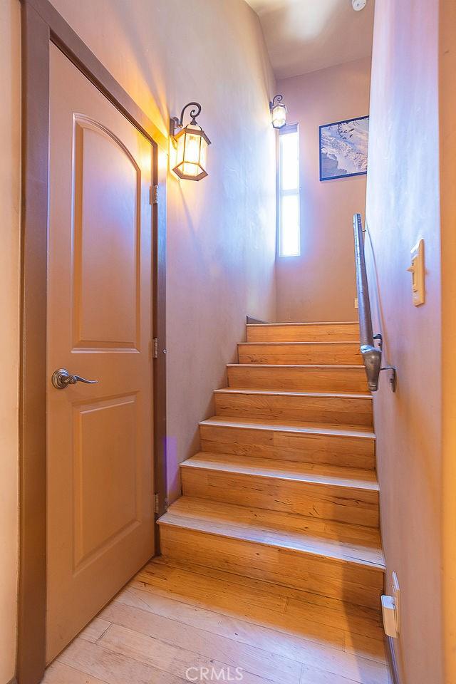 stairway featuring hardwood / wood-style flooring