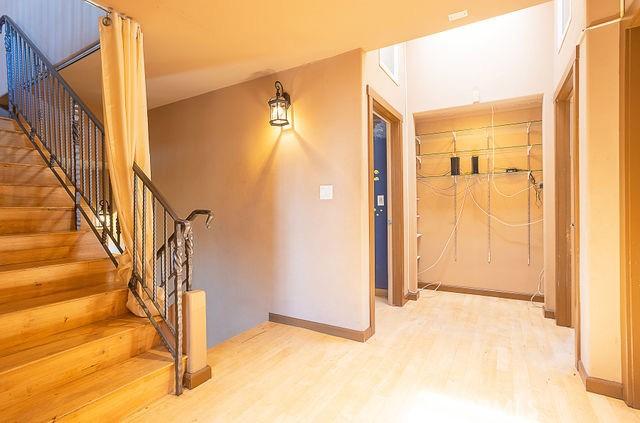 interior space featuring baseboards, stairway, and wood finished floors