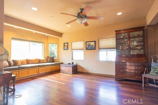 living room with a ceiling fan, baseboards, recessed lighting, and dark wood-type flooring