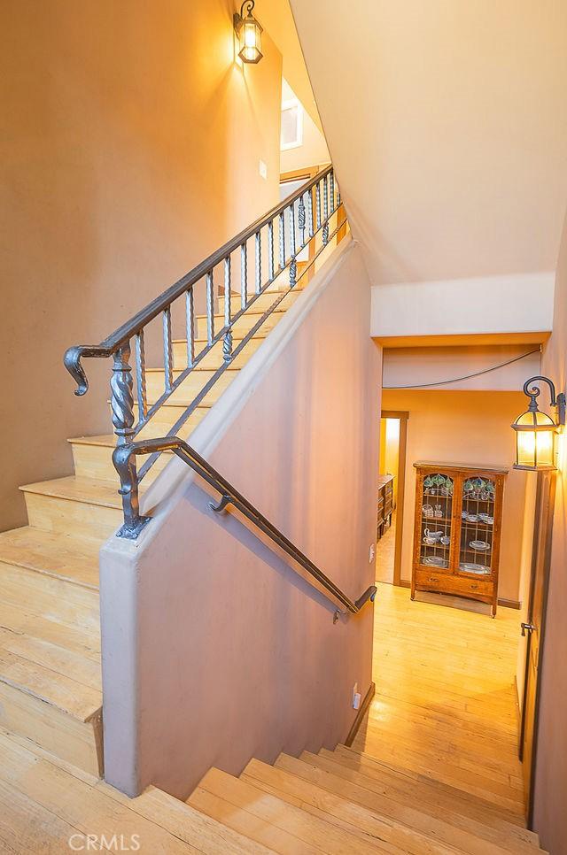 stairs featuring wood finished floors