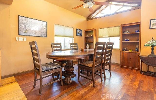 dining room with dark wood-type flooring, lofted ceiling, and ceiling fan