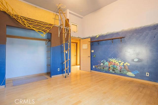 empty room with hardwood / wood-style flooring and lofted ceiling