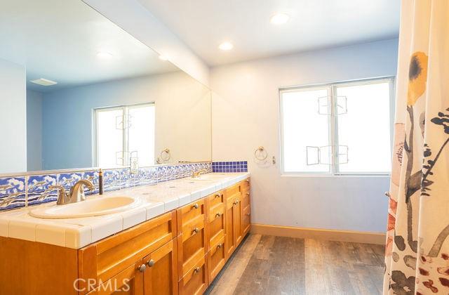 bathroom with vanity and hardwood / wood-style flooring