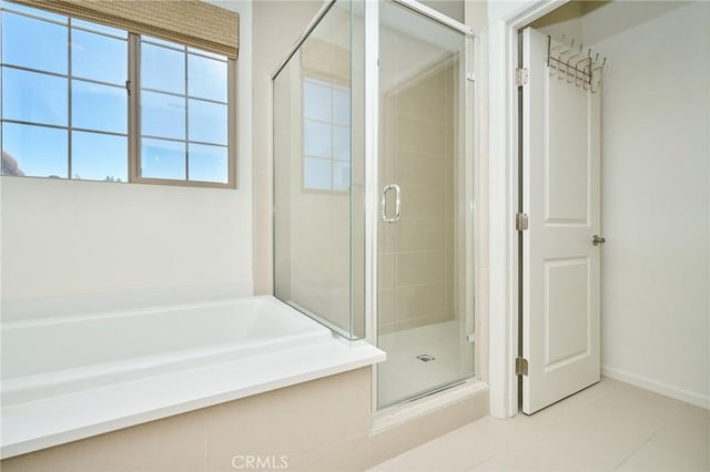 bathroom with tile patterned floors and independent shower and bath