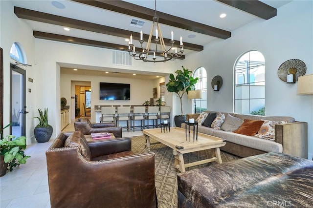 living room with beam ceiling and a notable chandelier