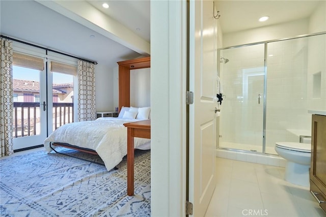 bedroom with french doors, connected bathroom, light tile patterned floors, and access to outside